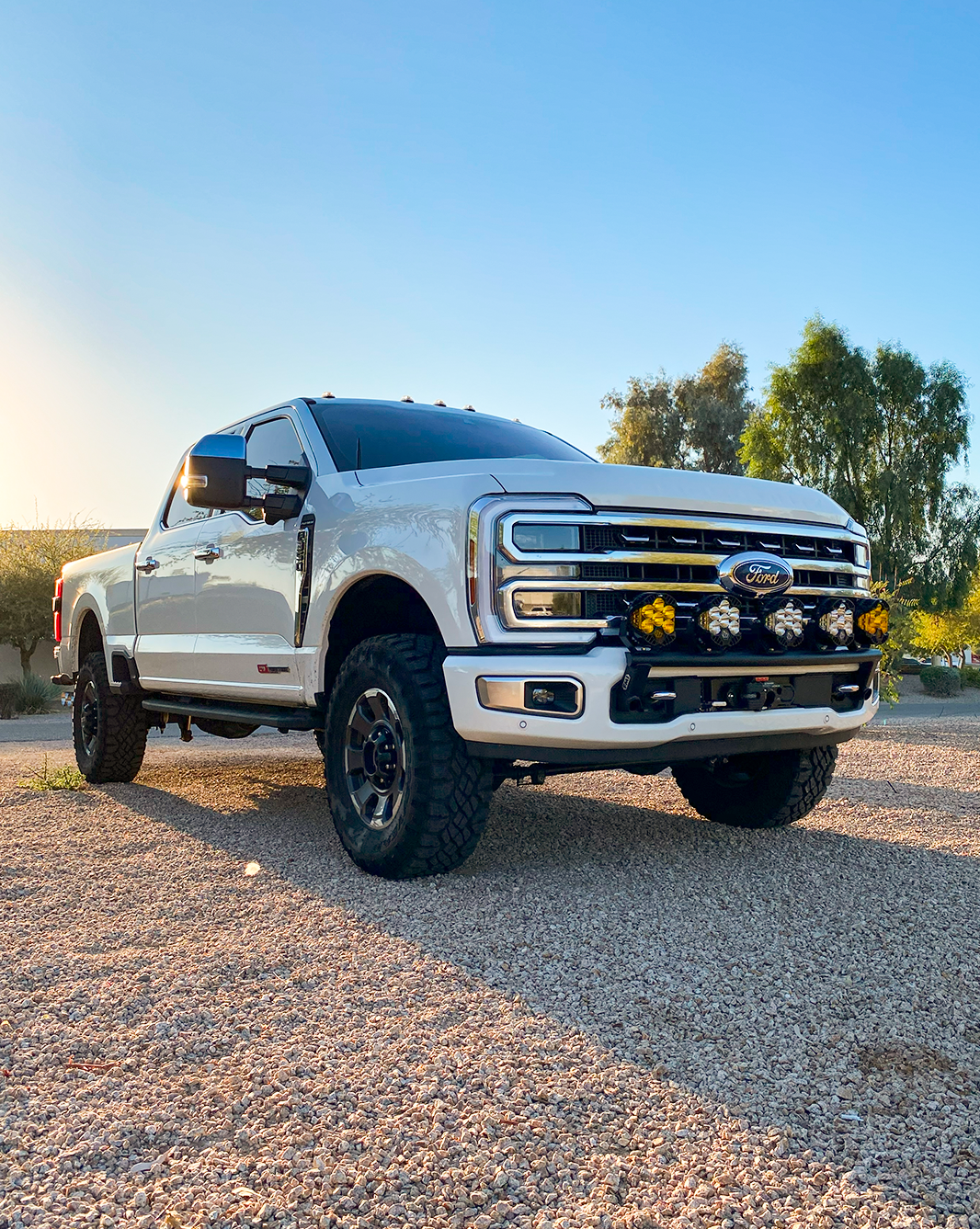 2023+ Ford F-250 Super Duty with front light mount kit installed on stock bumper, showcasing rugged offroad design.