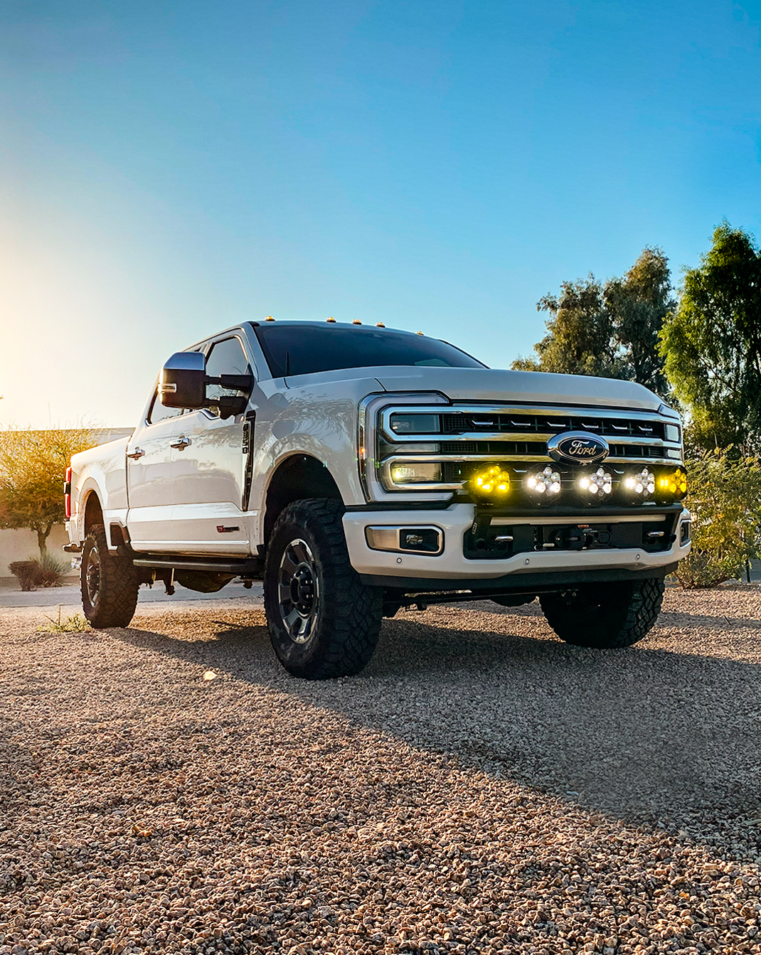 2023+ Ford F-250 Super Duty with front light mount kit installed on stock bumper, showcasing offroad lighting and rugged design.
