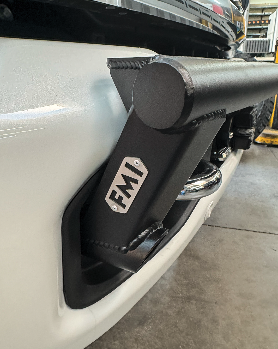 2023 Ford F-250 Super Duty front light mount kit attached to stock bumper, showcasing durable construction and design.