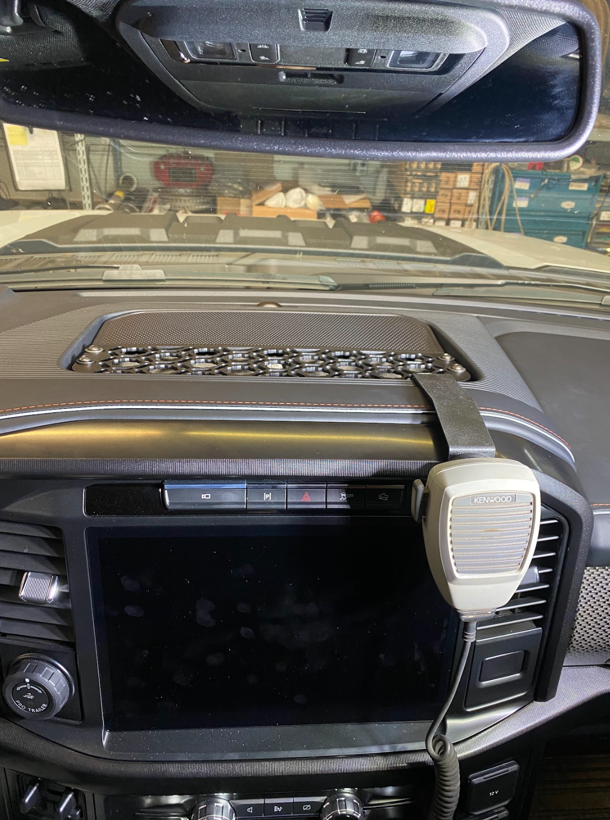 Center dash mount kit for 2024 F150 Raptor by Adapt-A-Panel, featuring a sleek design and integrated microphone holder.