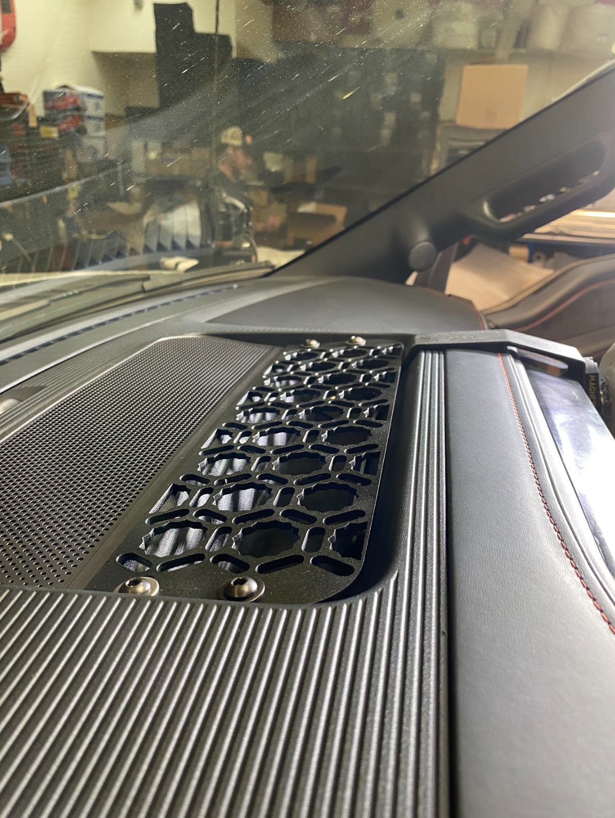 2024 F150 Raptor center dash mount kit by Adapt-A-Panel showcasing a textured surface and honeycomb design for enhanced functionality.