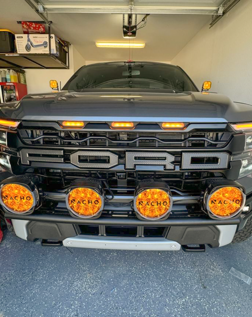 2024 Raptor Front Light Mount Kit on a black truck, featuring multiple lights mounted on a modular bumper for versatile lighting options.