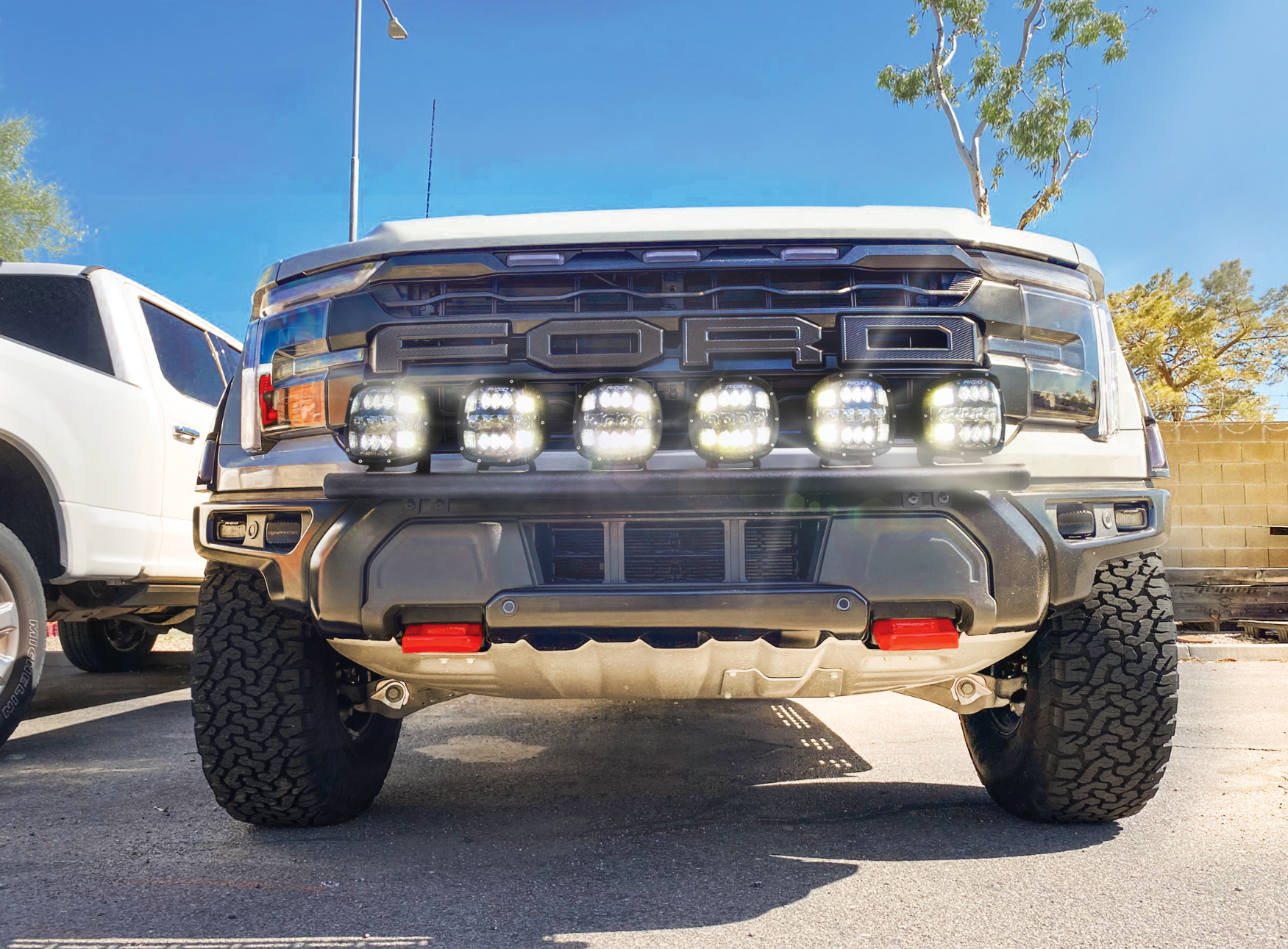 2024 Raptor Front Light Mount Kit on a truck, showcasing multiple lights mounted on a modular bumper for enhanced visibility.