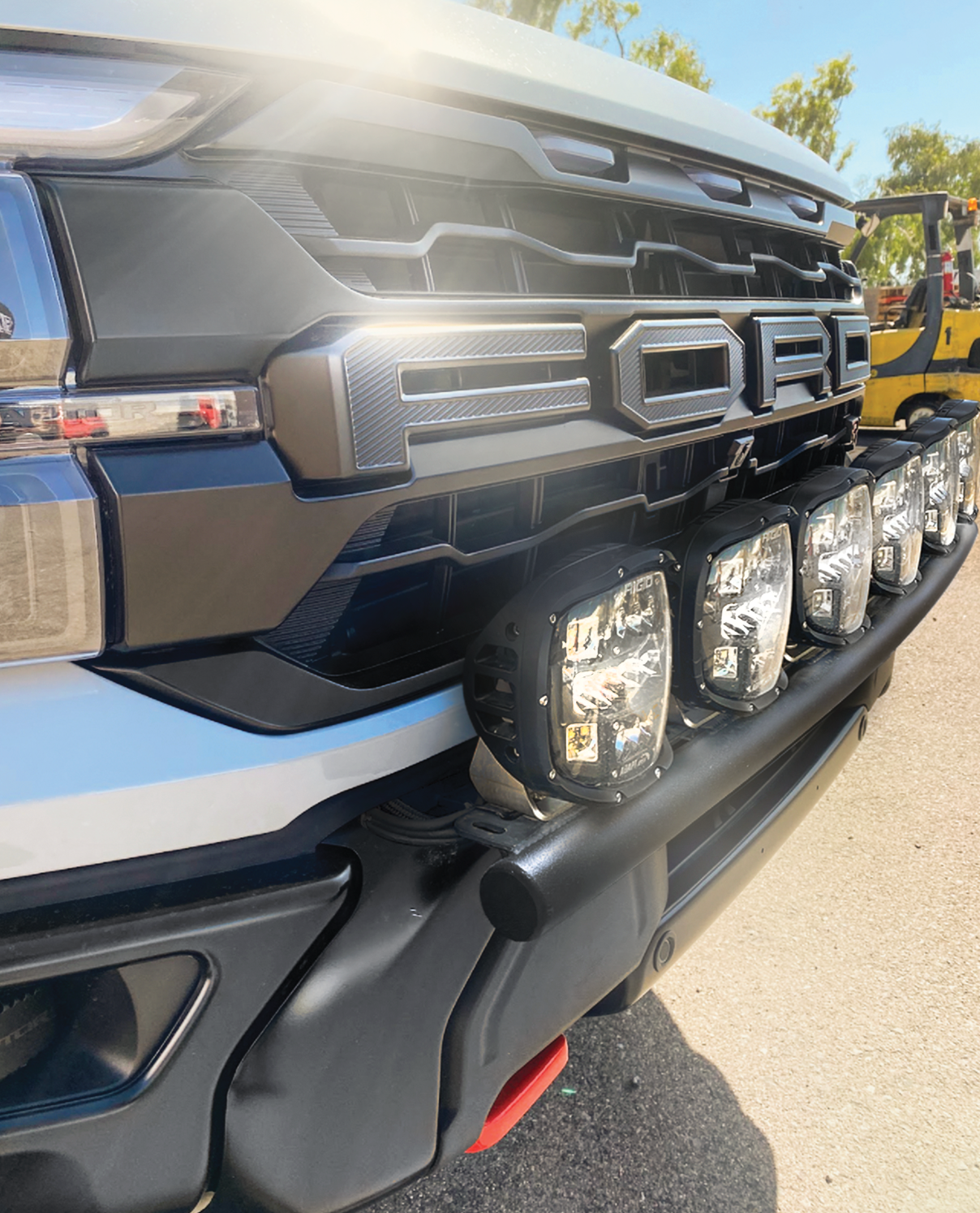 2024 Raptor front light mount kit on a modular bumper, showcasing multiple lights for enhanced visibility and style.