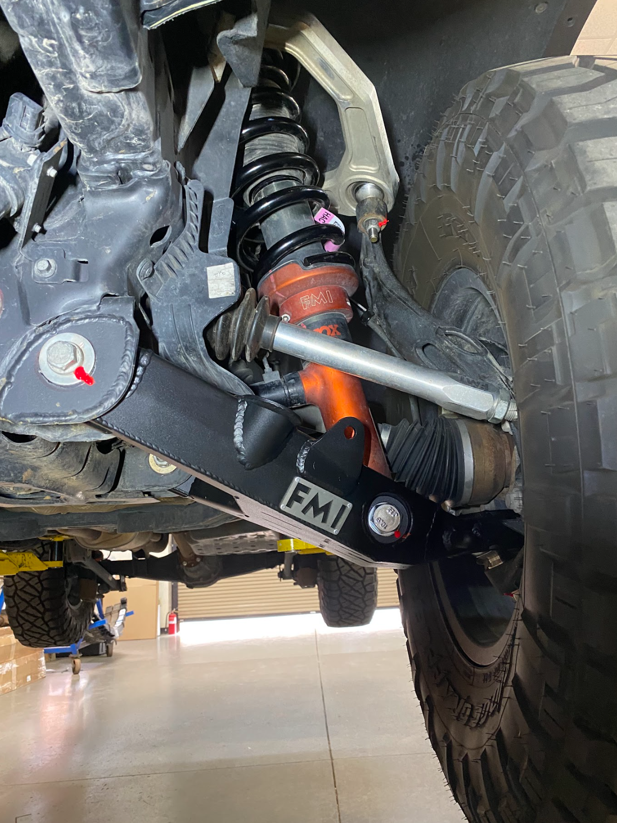 2024+ Ranger Raptor fabricated lower A-arm kit installed, showcasing stock width suspension components and rugged design.