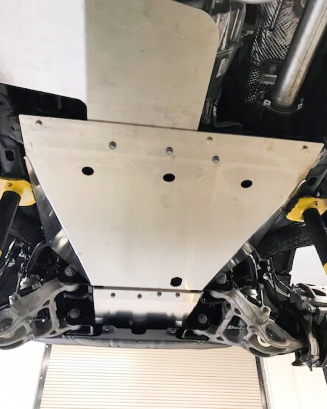 Underbody protection skid plate kit for 2025 Ram RHO, showcasing durable metal construction and precise fit for off-road safety.