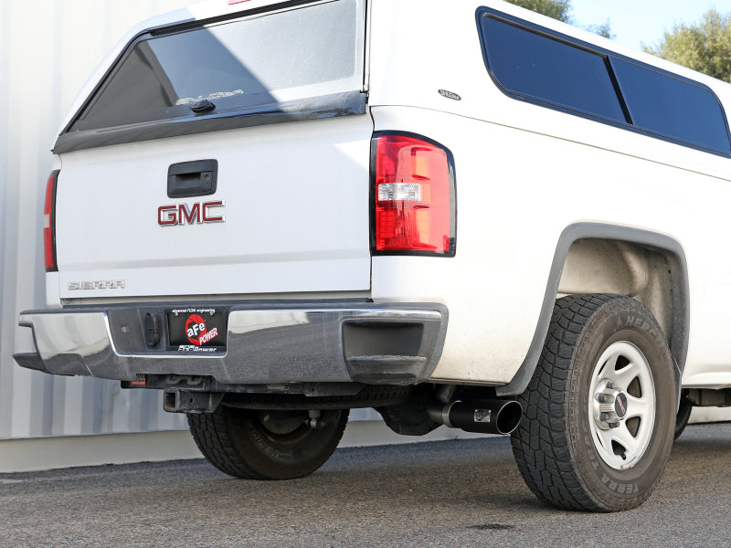 Afe Apollo GT Series Cat-Back Exhaust System installed on a white GMC truck, showcasing the rear view and dual exhaust tips.