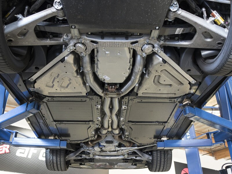 Underneath view of a Chevrolet Corvette C7 with an afe MACH Force-Xp X-Pipe, showcasing exhaust system components.