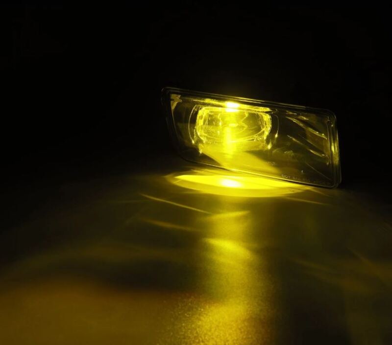 AlphaRex DoubleTap dual color LED fog light for 07-13 Chevrolet Silverado and 04-17 Tahoe, showcasing a bright amber glow.