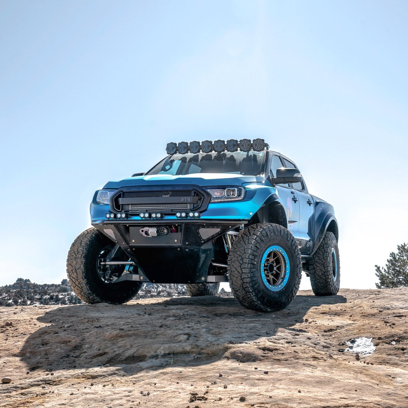 2019-2023 Ford Ranger bedsides showcasing a modified truck with offroad features and enhanced suspension on rocky terrain.