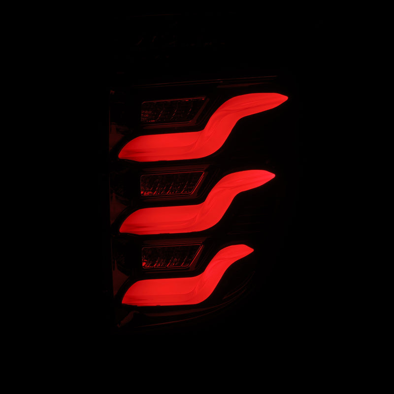 AlphaRex 11-15 Ford Explorer PRO-Series LED Tail Lights in jet black, featuring a sleek design with vibrant red illumination.