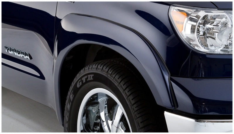 Black Bushwacker OE style flares for 2007-2013 Toyota Tundra, enhancing the truck's rugged look and fit with factory mudflaps.