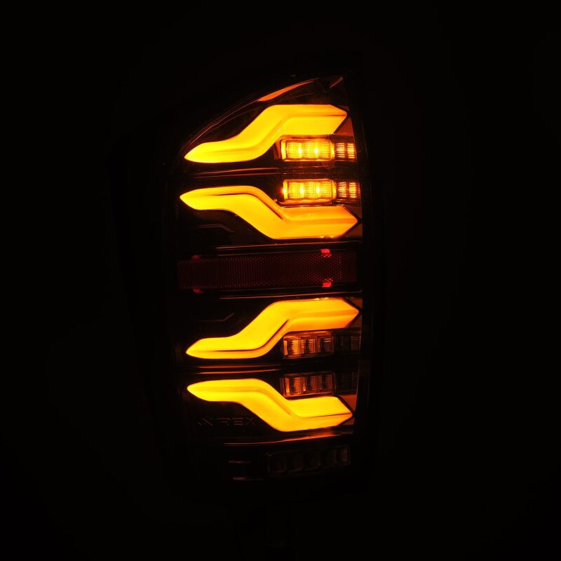 AlphaRex LED taillights for 16-21 Toyota Tacoma in black with sequential signal and activation lights.