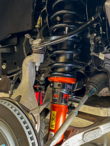 2021 and up Raptor front leveling kit showcasing a 2-inch or 1.5-inch lift with detailed suspension components.