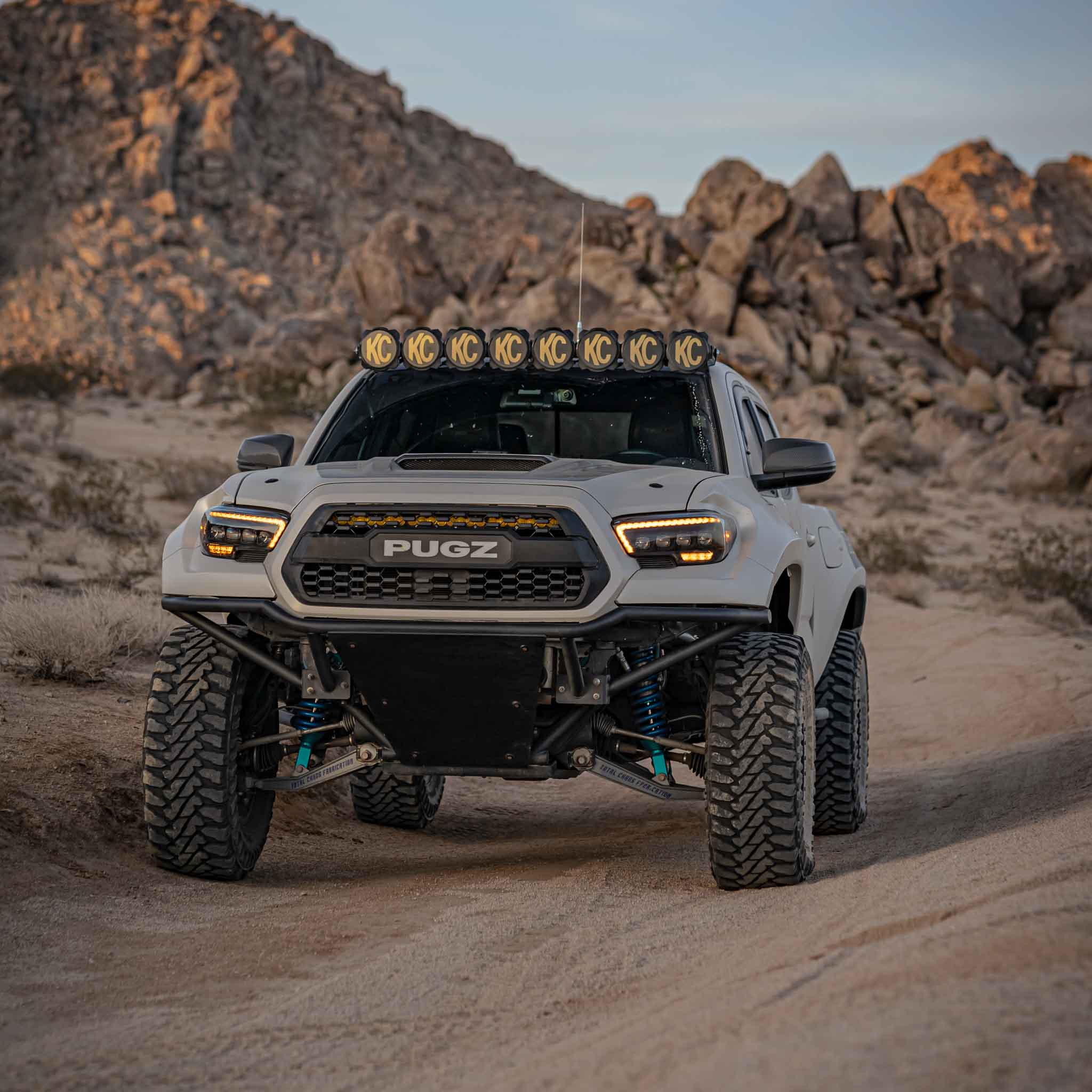2016-2023 Toyota Tacoma fenders on a modified truck in a desert landscape, showcasing off-road capabilities and rugged design.