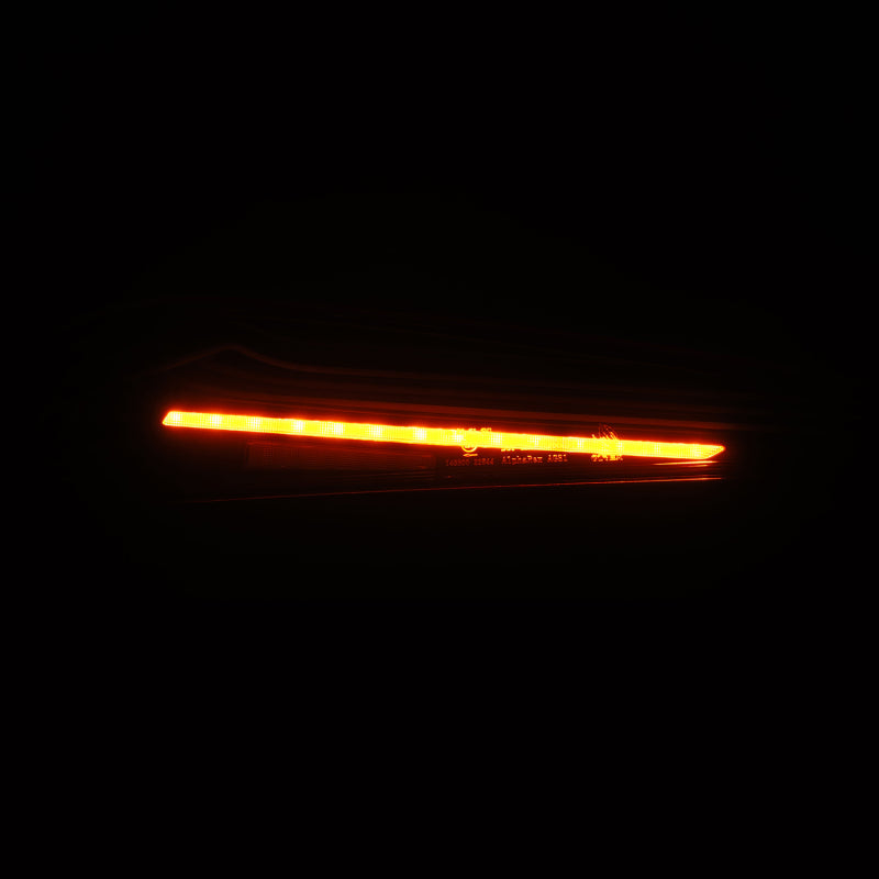 AlphaRex LUXX-Series LED tail lights for 20-24 Toyota Supra, featuring a sleek black design and bright orange illumination.