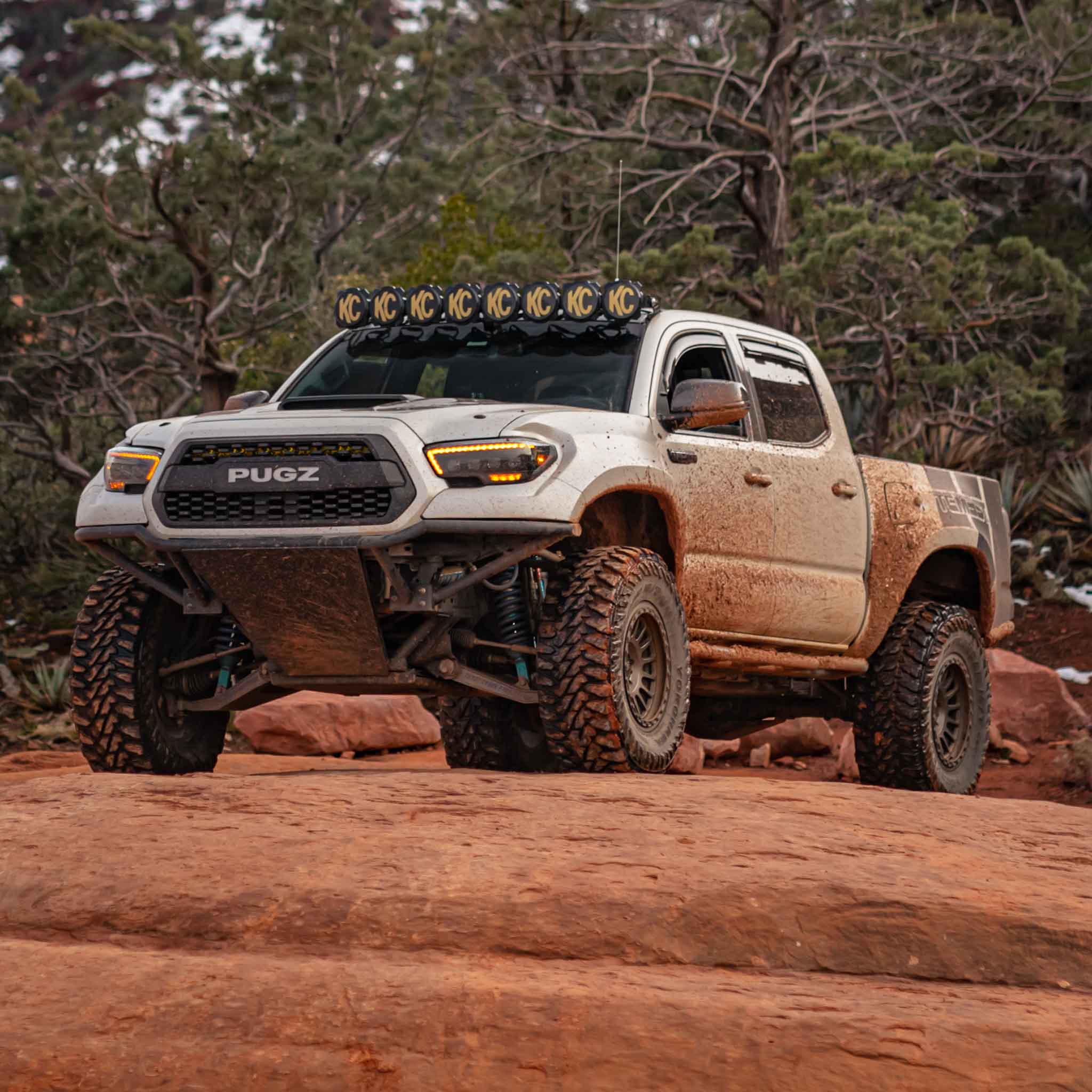 2016-2023 Toyota Tacoma fenders on a modified truck showcasing offroad capabilities in a rugged outdoor setting.