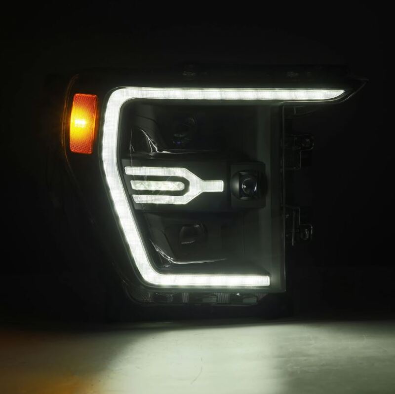 AlphaRex Luxx-Series projector headlights for 21-22 Ford F150 in black with activated light and sequential signal features.