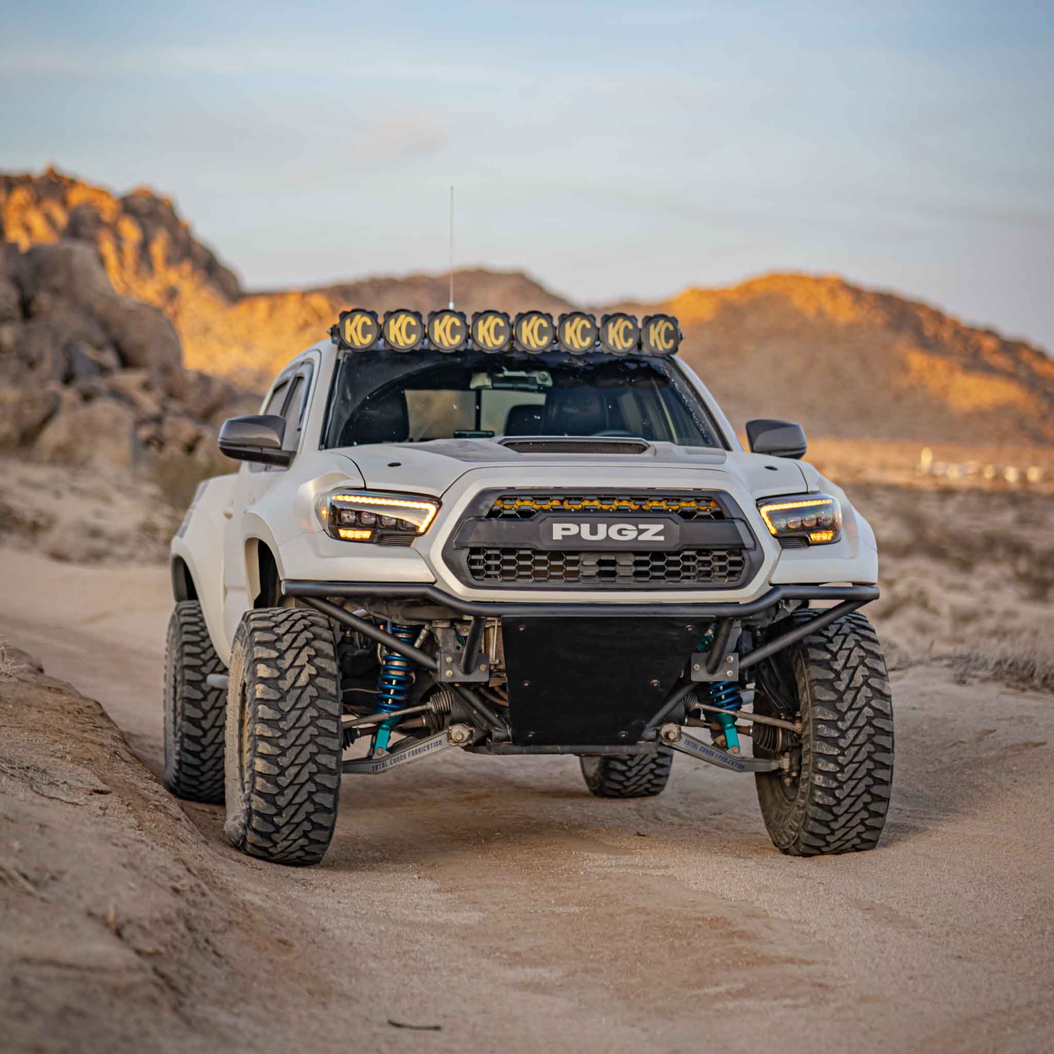 2016-2023 Toyota Tacoma with aftermarket fenders, showcasing rugged off-road capabilities in a desert landscape.