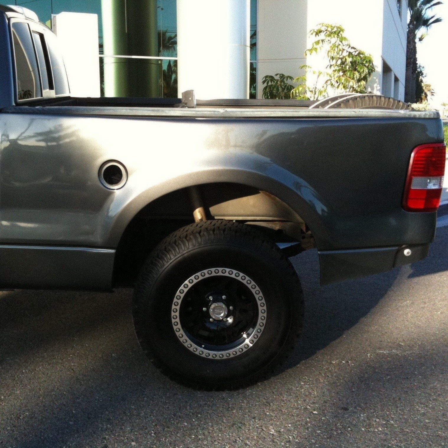 2004-2008 Ford F-150 with aftermarket bedsides, showcasing a lifted stance and offroad tires for enhanced performance.