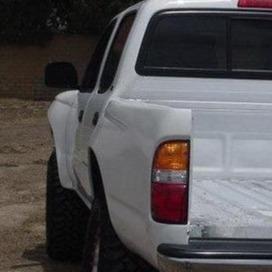 1995-2004 Toyota Tacoma bedsides showcasing a white truck with a rugged design and offroad-ready features.