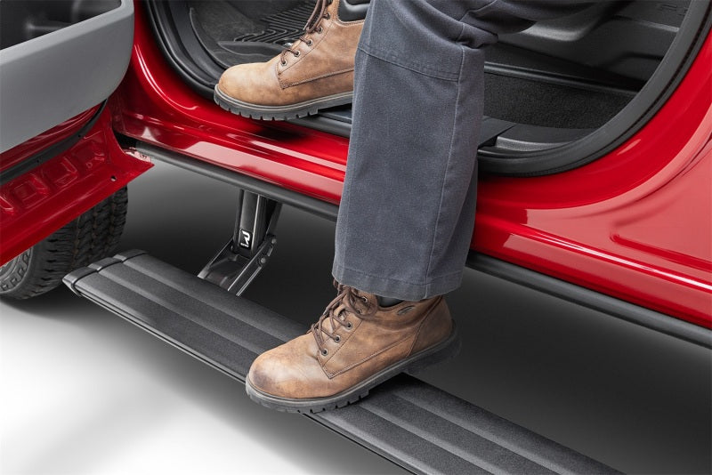 AMP Research PowerStep Vision for 2013-2017 Dodge Ram, showcasing a foot stepping onto the retractable running board.