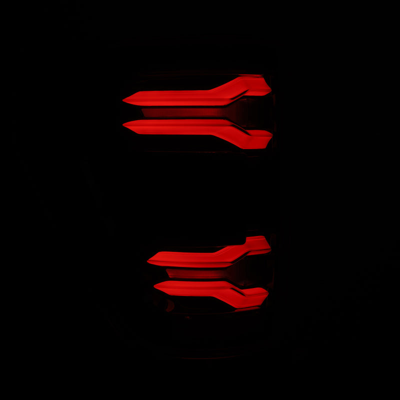 AlphaRex 21-23 Ford F-150 LUXX LED taillights in Alpha-Black with BLIS feature a sleek design and vibrant red illumination.