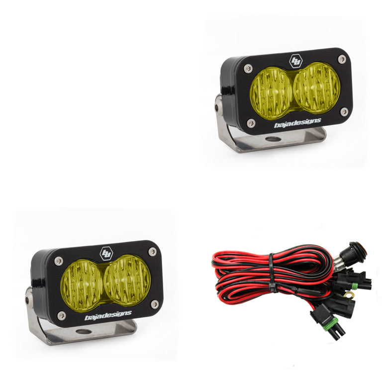 Baja Designs S2 Pro LED lights in amber, featuring wide cornering optics, with mounting brackets and wiring harness included.