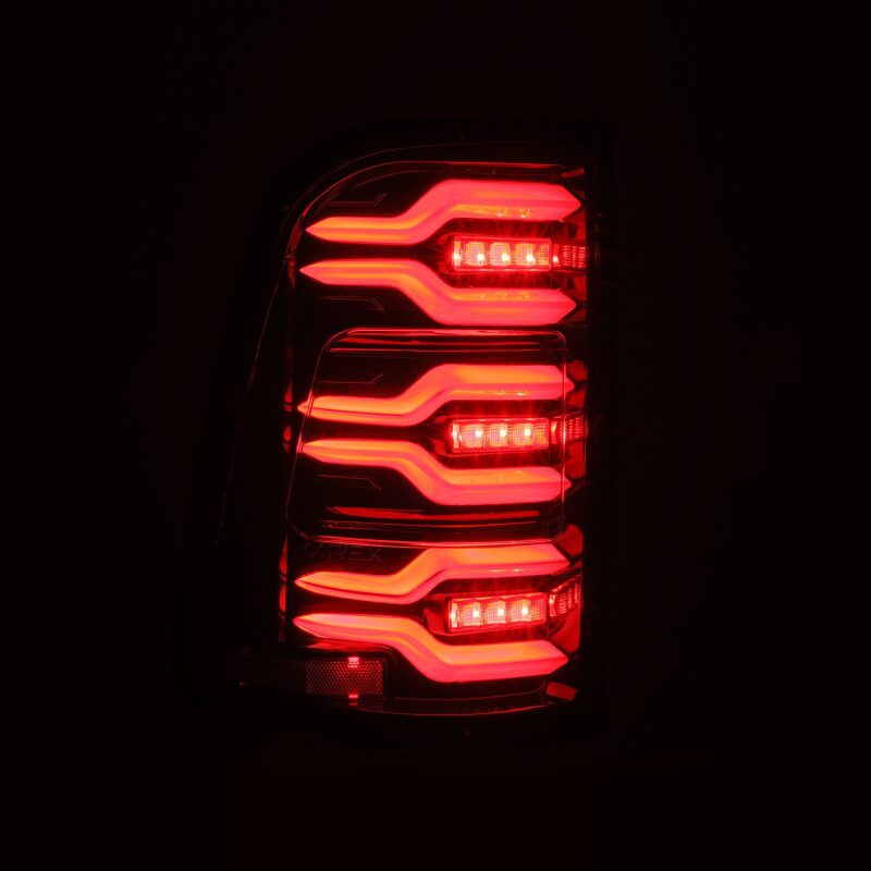 AlphaRex Luxx-Series LED tail lights for 19-21 Dodge Ram 1500 in Alpha-Black with sequential signal and active lighting.