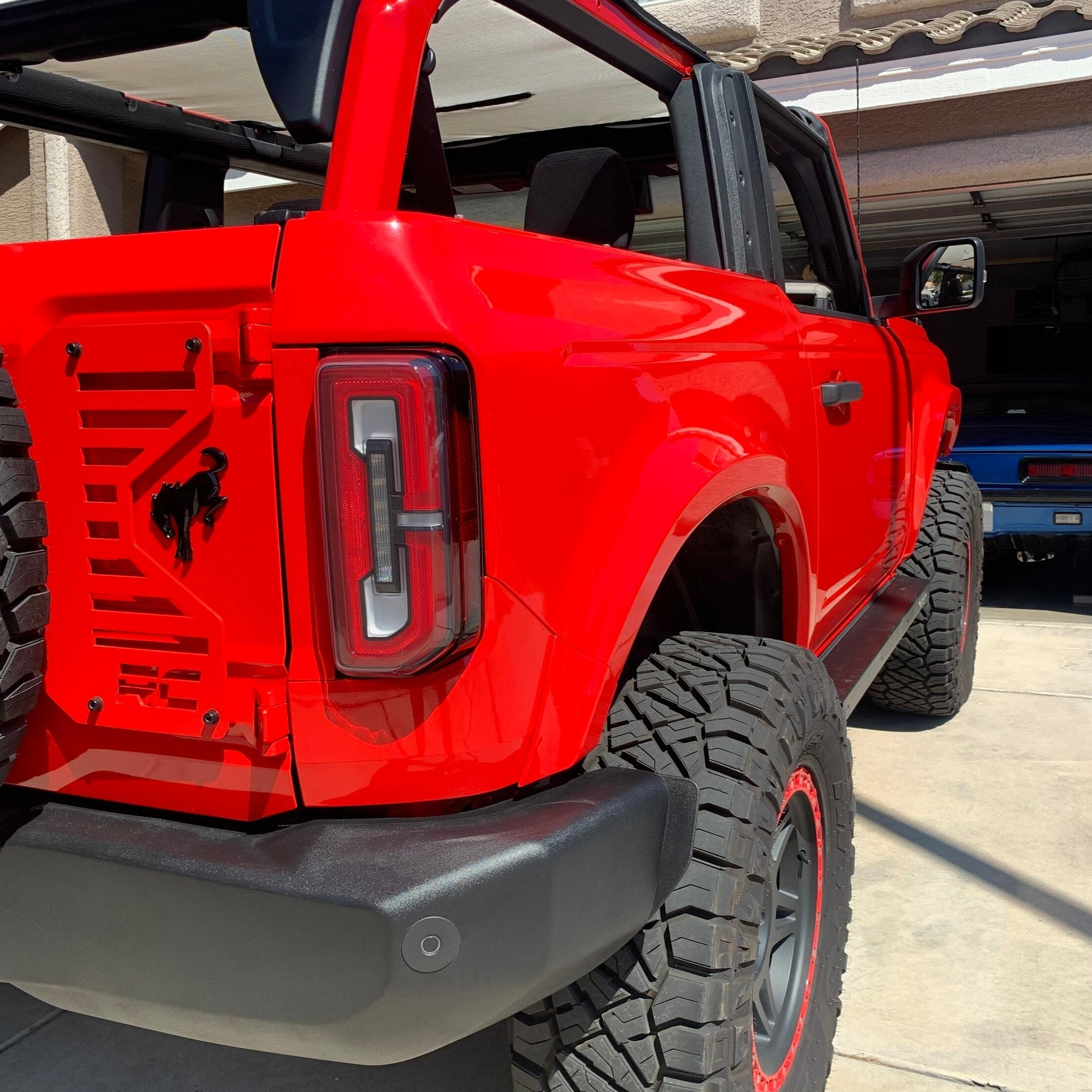 2021-2025 Ford Bronco 2-Door Rear Quarter Kit installed on a red Bronco, showcasing its rugged design and off-road capabilities.