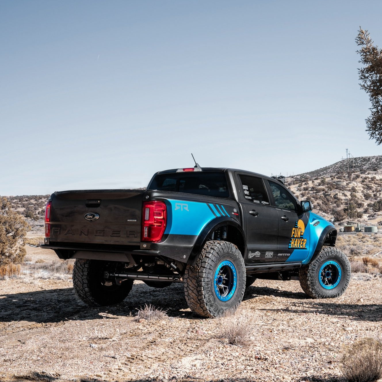 2019-2023 Ford Ranger with custom bedsides, showcasing offroad tires and a rugged design in a desert landscape.