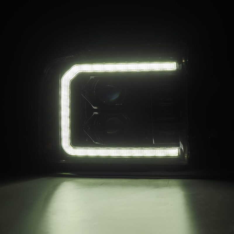 AlphaRex PRO-Series projector headlights for 05-07 Ford F250-550 in alpha-black with LED accents.