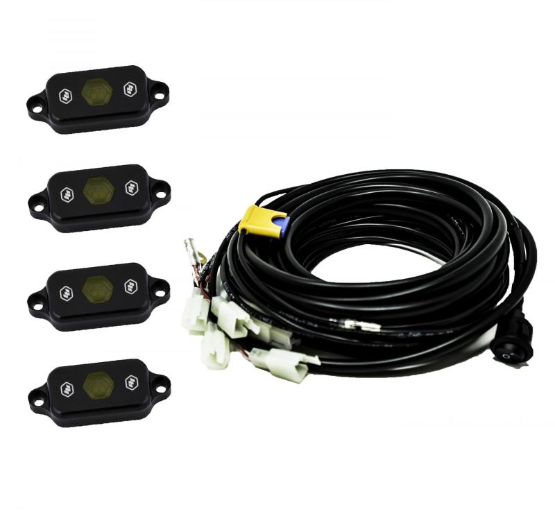 Baja Designs Universal Amber Rock Light Kit with four lights and wiring harness for offroad vehicle illumination.