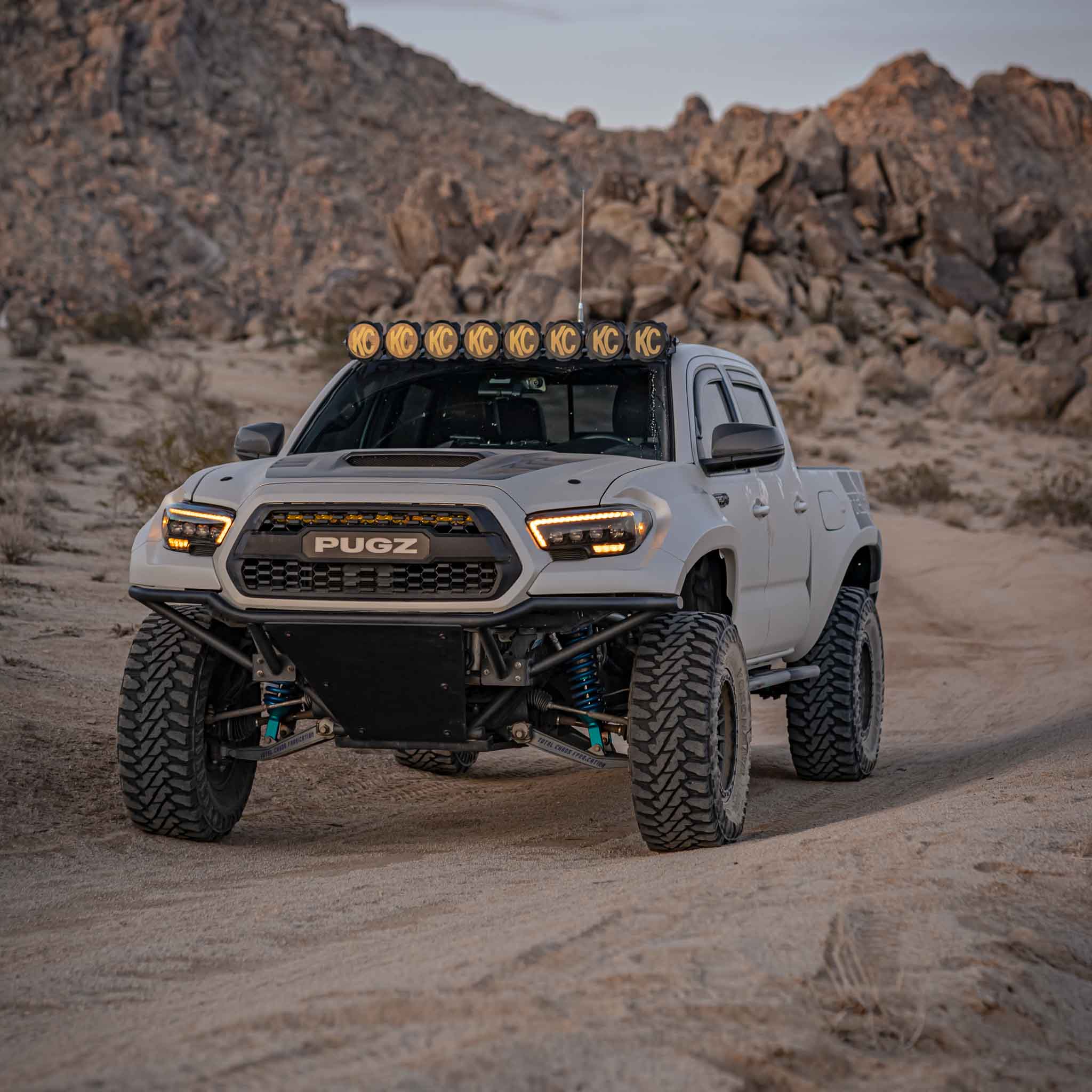 2016-2023 Toyota Tacoma fenders showcased on a modified truck in a rugged desert landscape.