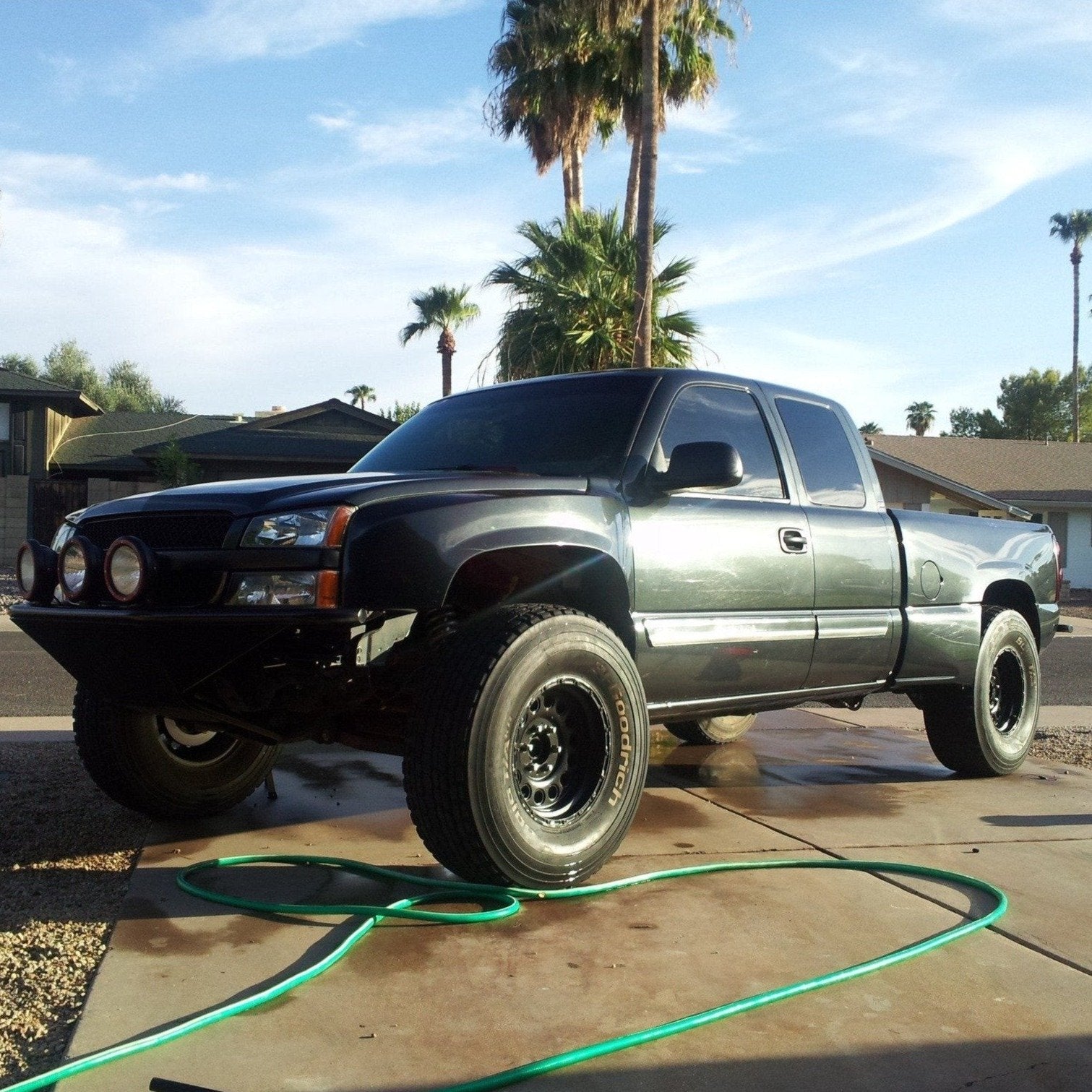 2003-2006 Chevrolet Silverado fenders displayed on a lifted truck in a residential setting, showcasing offroad capabilities.