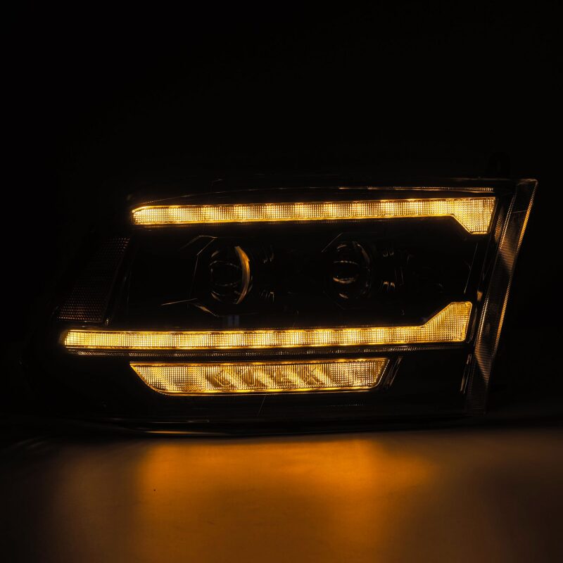 AlphaRex 09-18 RAM 1500 PRO-Series projector headlights in alpha-black with sequential signal and DRL features.