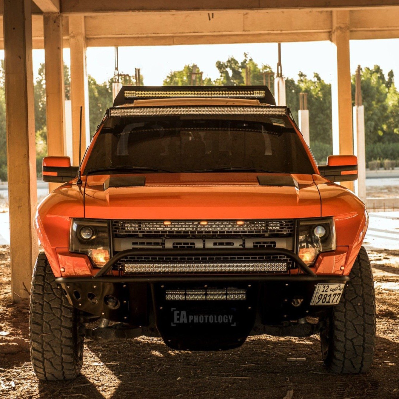 2010-2016 Ford Raptor fenders showcased on an orange truck under construction, highlighting offroad capability and style.