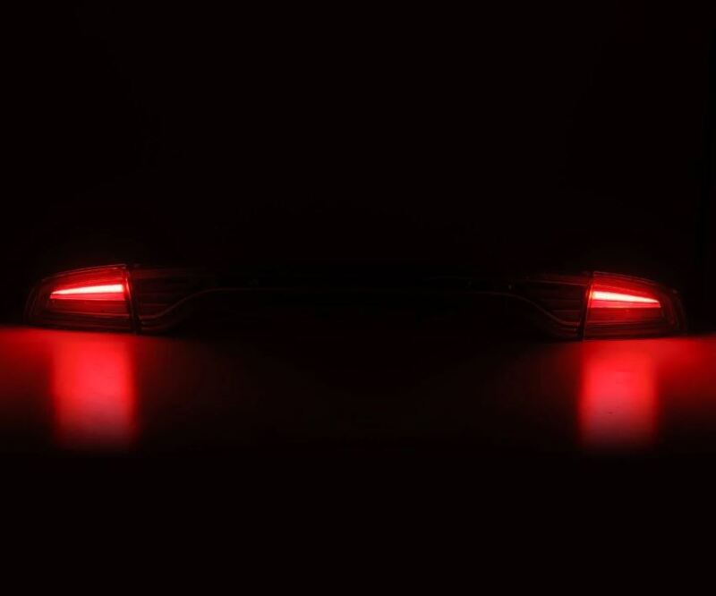 AlphaRex 15-23 Dodge Charger Nova-Series LED tail lights in Alpha-Black, featuring a sleek design and bright red illumination.