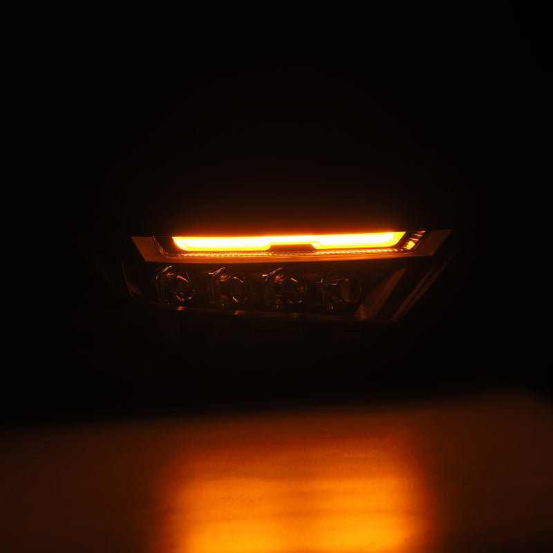 AlphaRex LED projector headlights for 2019-2023 Toyota RAV4 in black, featuring a striking amber light strip.