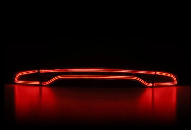 AlphaRex 15-23 Dodge Charger Nova-Series LED tail lights in smoke finish, featuring a sleek, modern design with vibrant red illumination.