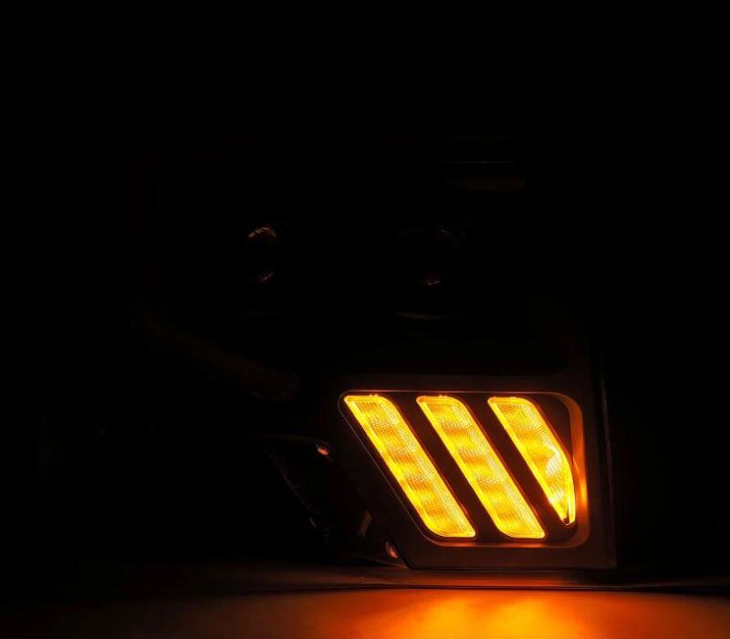 AlphaRex PRO-Series projector headlights for 09-14 Ford F-150 with black finish and sequential amber signal lights.