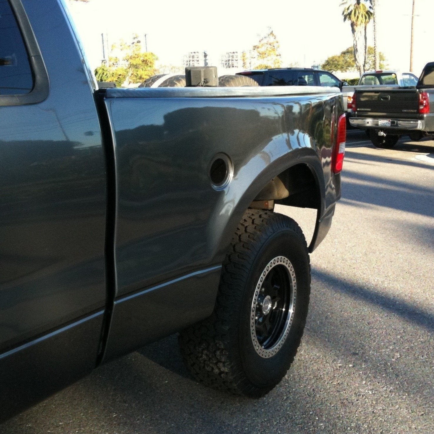 2004-2008 Ford F-150 bedsides showcasing a gray truck with off-road tires, highlighting durability and style.