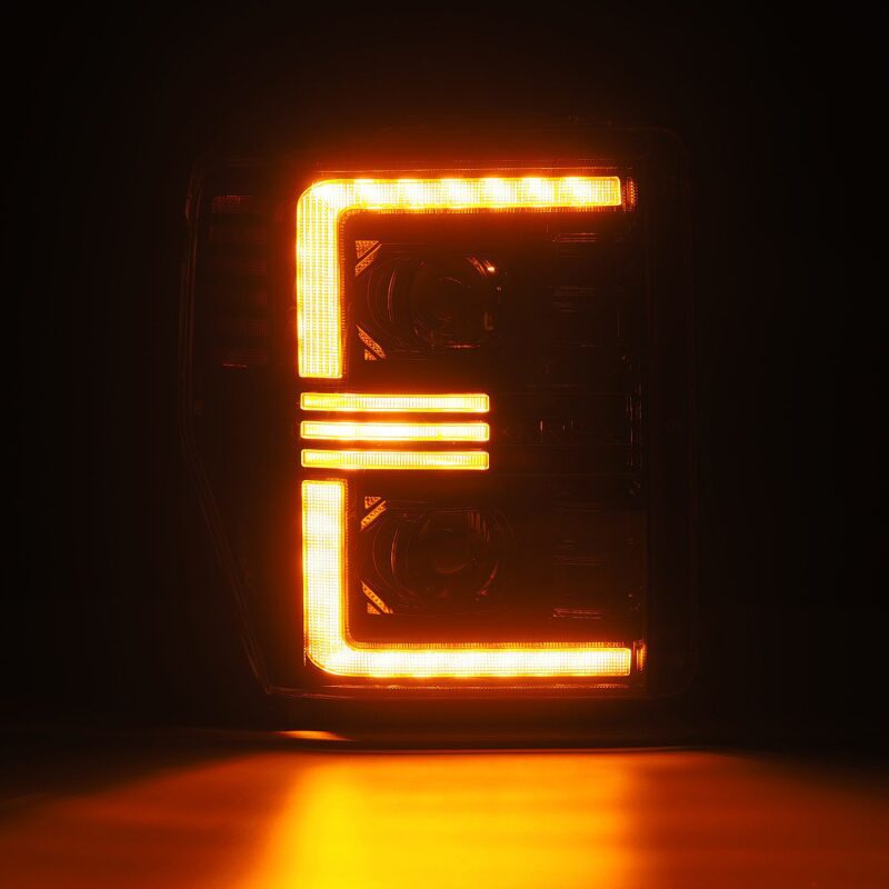 AlphaRex PRO-Series projector headlights for 08-10 Ford F250-550 in black with sequential signal and active light features.