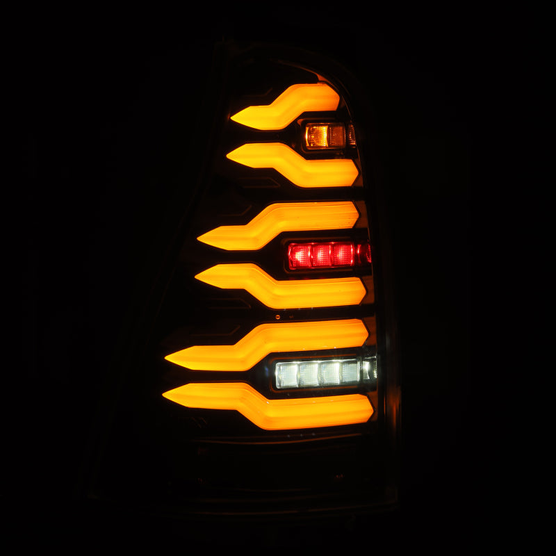 AlphaRex LUXX-Series LED tail lights for 03-09 Toyota 4Runner in black, featuring a modern design with bright amber and red lighting.
