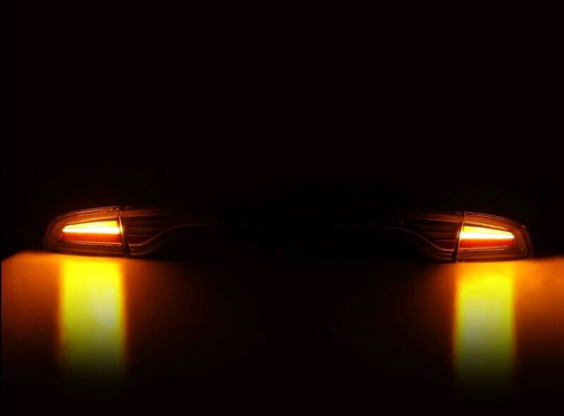 AlphaRex Nova-Series LED tail lights for 15-23 Dodge Charger in smoke finish, showcasing bright amber turn signals.