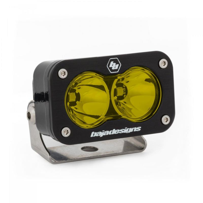 Baja Designs S2 Pro amber LED light with dual lenses, mounted on a metal bracket for offroad visibility.