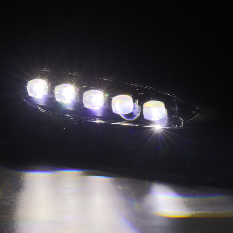 AlphaRex NOVA LED projector headlights for 12-21 Tesla Model S in black with sequential signals and daytime running lights.