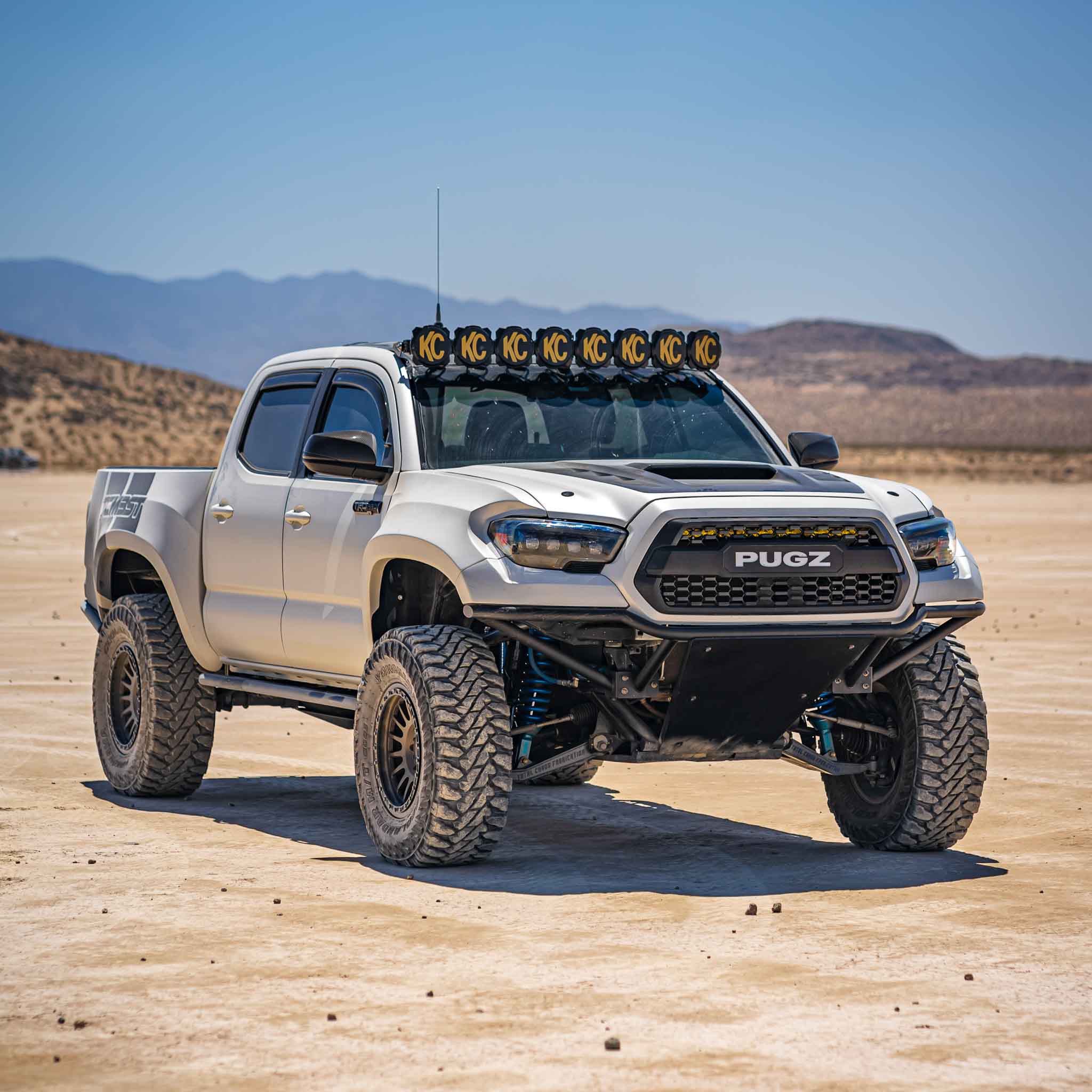 2016-2023 Toyota Tacoma fenders on a lifted truck in a desert setting, showcasing offroad capabilities and rugged design.