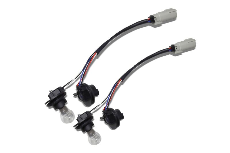 Wiring adapter for 2018-2020 Ford F-150 to connect OEM to AlphaRex taillights, featuring two connectors and wiring harness.