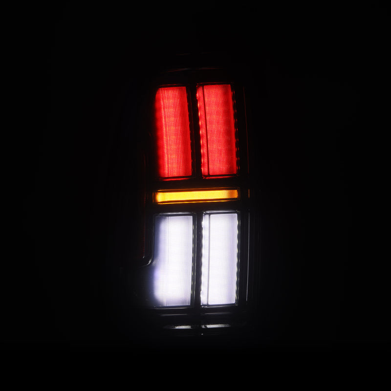 AlphaRex NOVA Prismatic LED tail lights for 05-15 Toyota Tacoma in Alpha-Black, featuring vibrant red, white, and amber lighting.